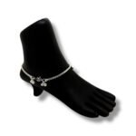 A silver chain featuring a delicate charm alongside a beautifully crafted bird anklet set.